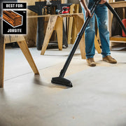 Craftsman CMXZVBE38741 vacuum cleaning sawdust on workshop floor, person holding wand.