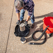 Photo of a person installing a pleated filter into a Craftsman wet/dry vacuum, SKU CMXZVBE38755, with hose and red canister visible.