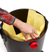Photo of Craftsman CMXZVBE38769 yellow vacuum filter bag being installed in black canister, top view.