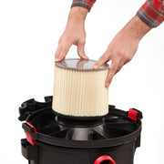Photo of hands installing Craftsman CMXZVBE38854 pleated vacuum filter into a black shop vacuum base, white background.