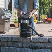 Photo of Craftsman ash vacuum CMXZVBE43268 with hose and filter outdoors on stone wall.