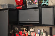 A black CRAFTSMAN wall-mounted storage cabinet with a lockable door, installed above a workbench organized with tools and