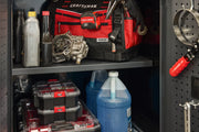 A storage cabinet containing a red and black CRAFTSMAN tool bag, various bottles and containers, metal parts, organized
